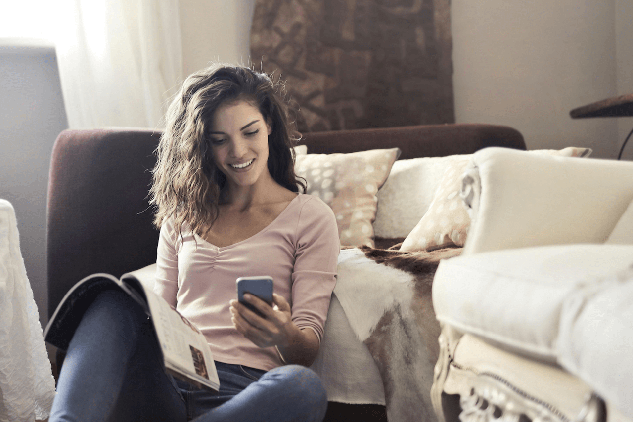 woman-in-pink-long-sleeve-shirt-and-blue-denim-jeans-sitting-on-floor